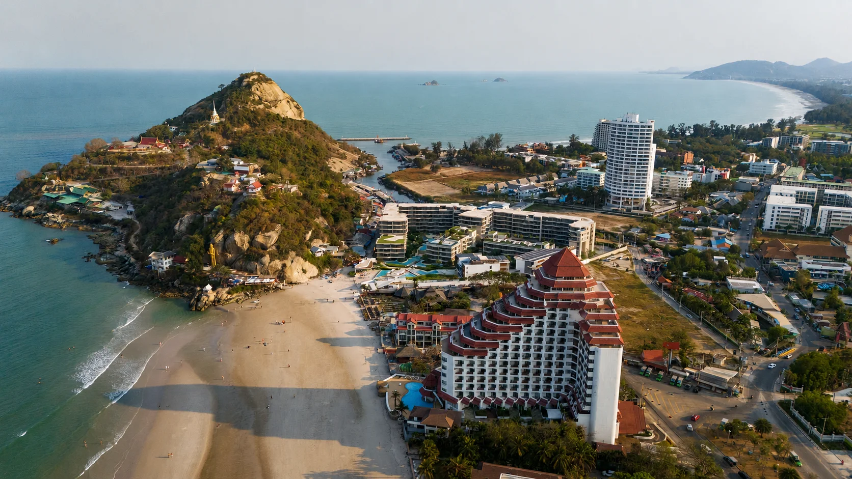 Khao Takiab limestone hill rising above the beach and the town